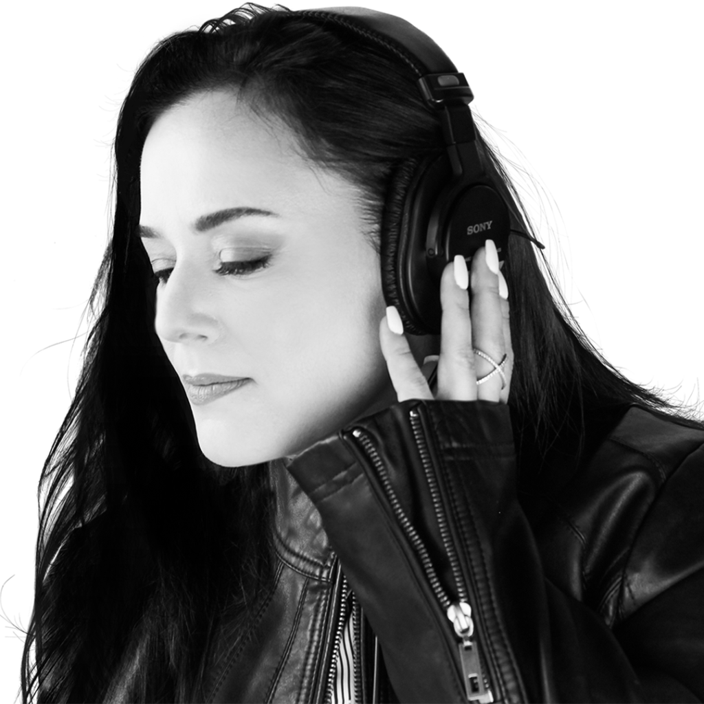 Black and while headshot of voiceover artist Catherine Provenza wearing a leather jacket and headphones.