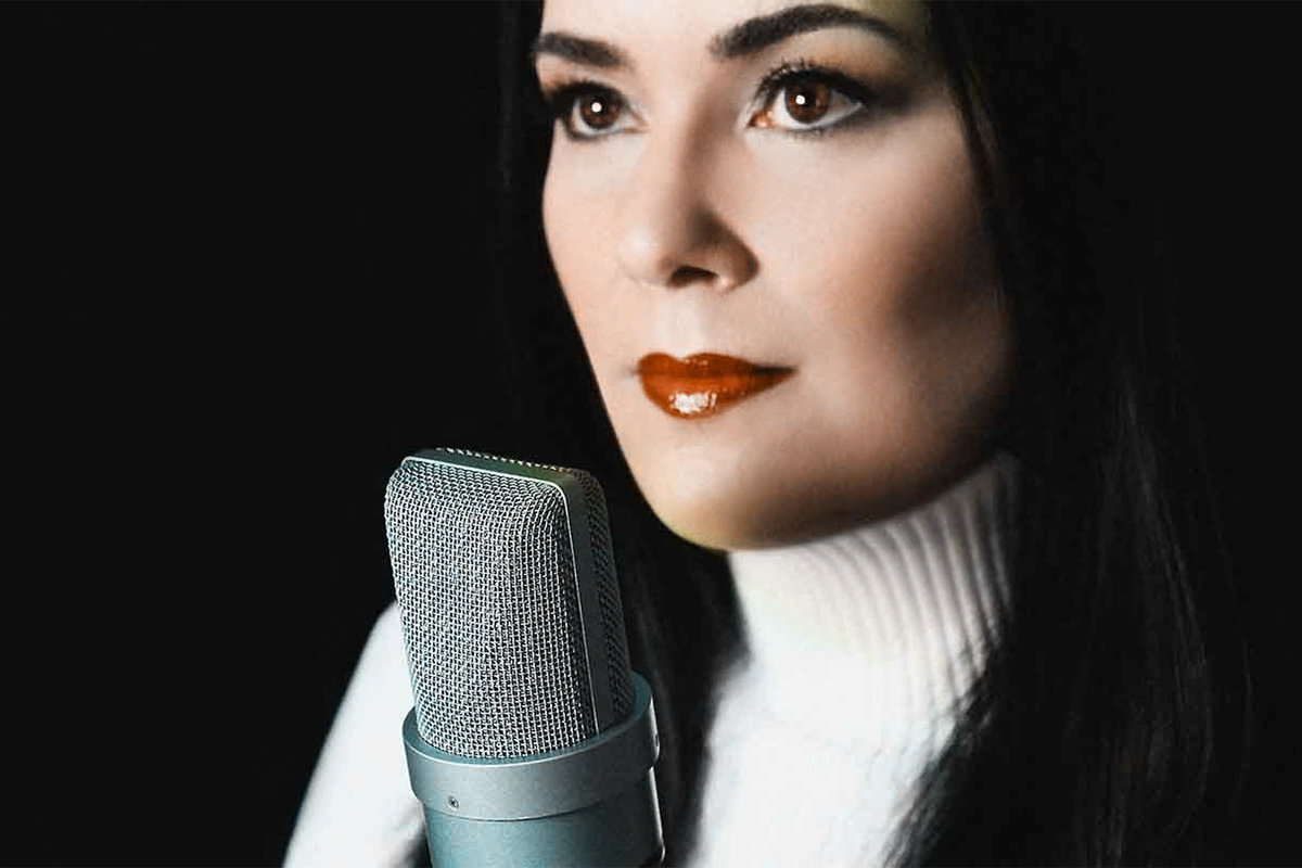 Catherine Provenza professional female voiceover artist speaking into studio microphone